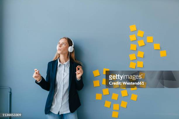 young busensswoman relaxing, listening music - clicking fingers stock pictures, royalty-free photos & images