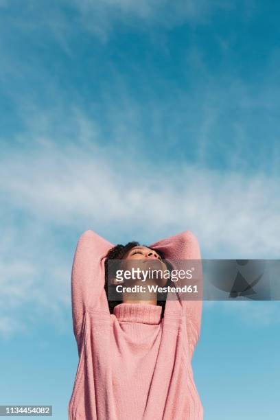 relaxed young woman wearing pink turtleneck pullover enjoying fresh air - huvudet bakåt bildbanksfoton och bilder