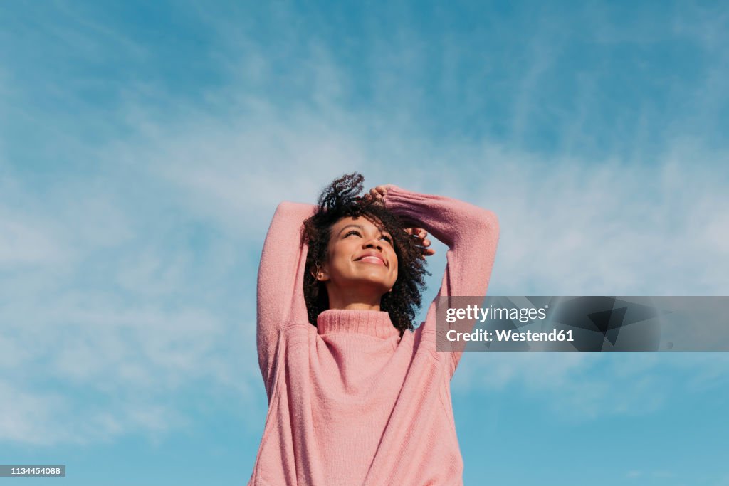 Portrait of happy young woman enjoying sunlight