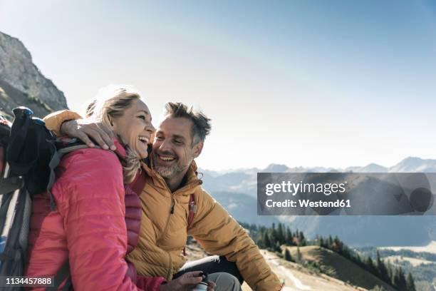 austria, tyrol, happy couple having a break during a hiking trip in the mountains - mature travellers stock pictures, royalty-free photos & images