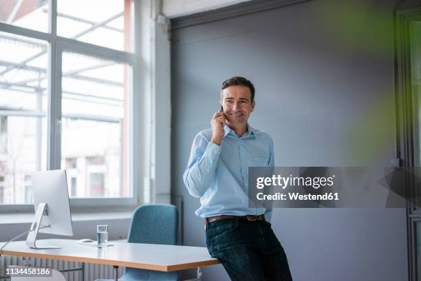 smiling businessman on cell phone in the office - casual businessman glasses white shirt stock pictures, royalty-free photos & images