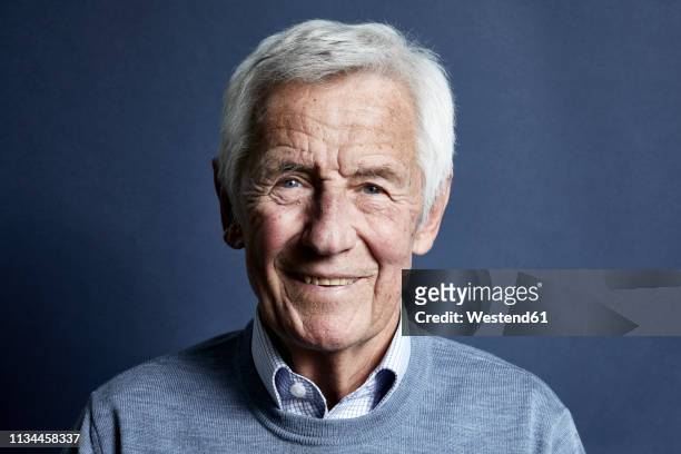 portrait of smiling senior man - senior man stock-fotos und bilder