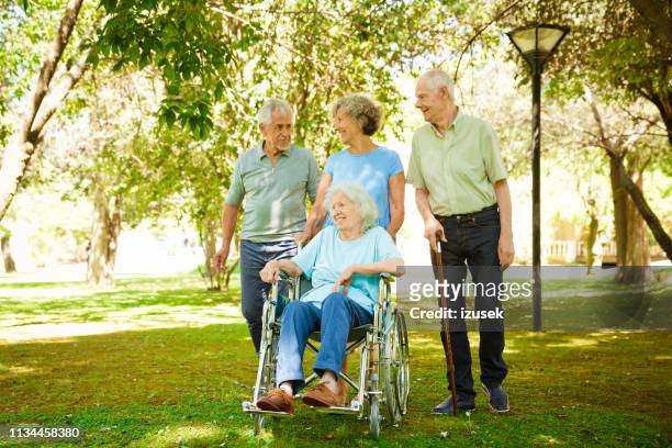 smiling retired senior men and women at back yard - retirement community staff stock pictures, royalty-free photos & images
