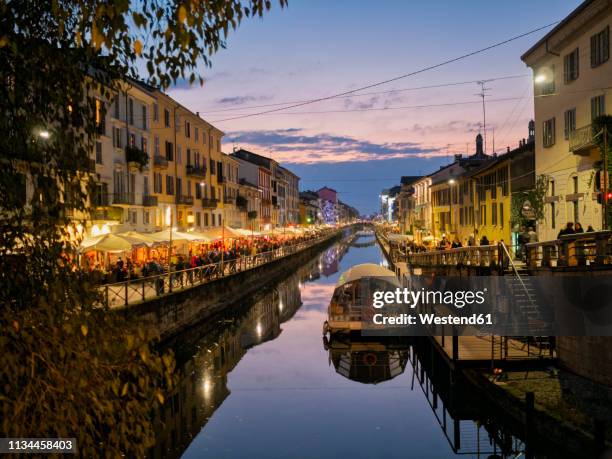 italy, milan, porta nuova, navigli, naviglio grande at dusk - milan navigli stock pictures, royalty-free photos & images