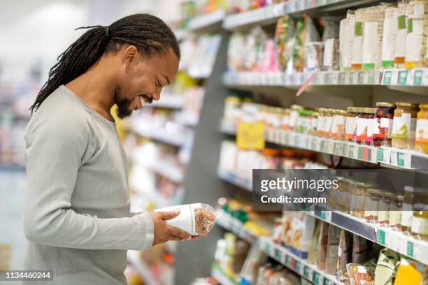 reading label on cereales - cereales stock pictures, royalty-free photos & images