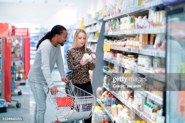 couple choosing oatmeal - use by label stock pictures, royalty-free photos & images