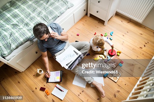 Father with his little son working from home Father with his little son working from home
