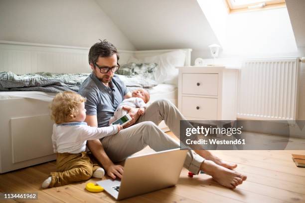 father with his little son and baby daughter working from home - working from home stress stock pictures, royalty-free photos & images