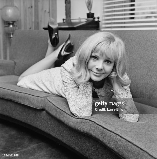 English actress and fashion model Barbara Ferris lying on a couch, UK, 5th January 1965.