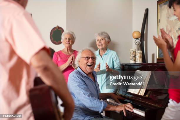 elderly people making music in retirement home - playing music stock pictures, royalty-free photos & images