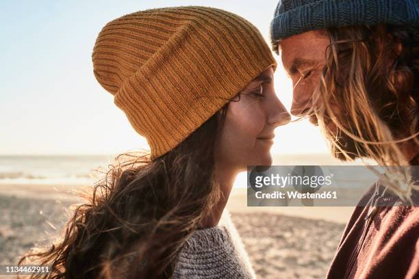 portugal, algarve, affectionate couple on the beach at sunset - nozes stock pictures, royalty-free photos & images