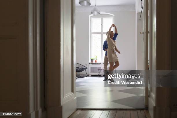 mature couple dancing at home - 50 59 years home stock pictures, royalty-free photos & images