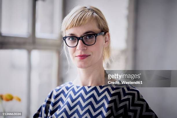 portrait of blond businesswoman wearing glasses - smart fashion stock-fotos und bilder