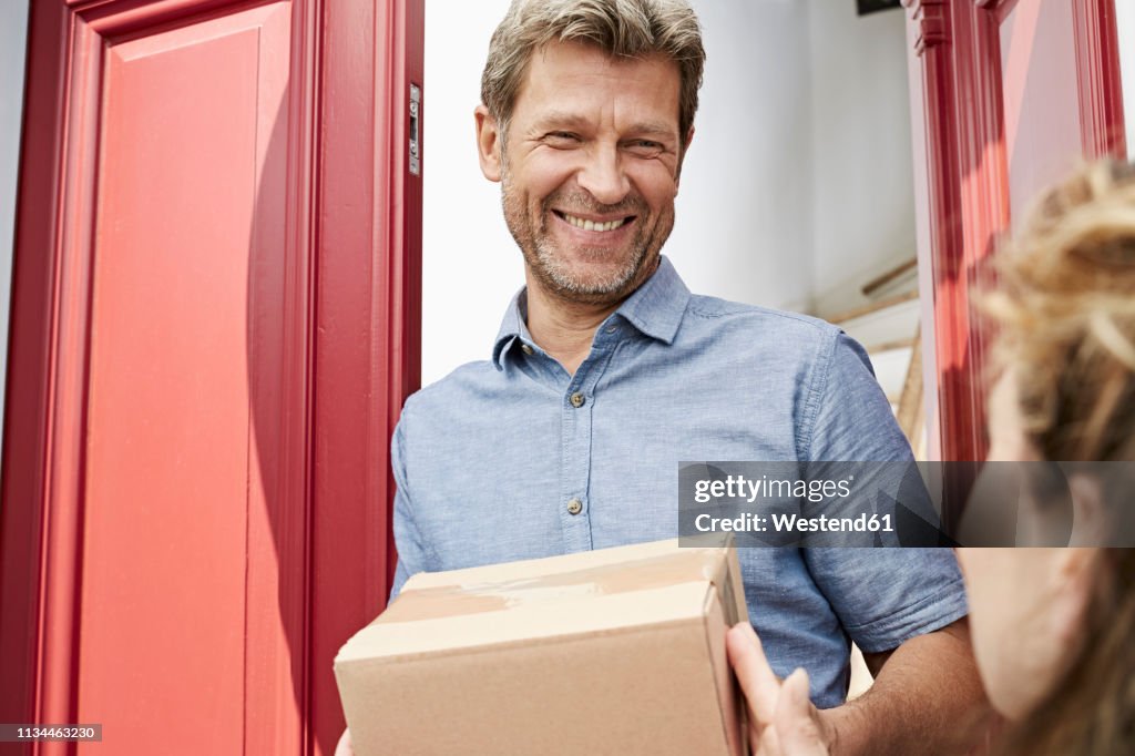 Mature man receiving a package at his door