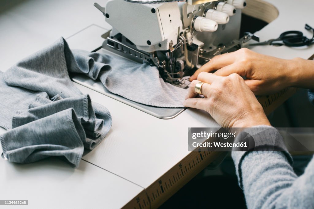 Close-up of woman using sewing machine