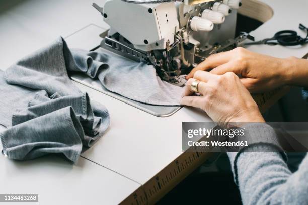 close-up of woman using sewing machine - textile factory stock pictures, royalty-free photos & images