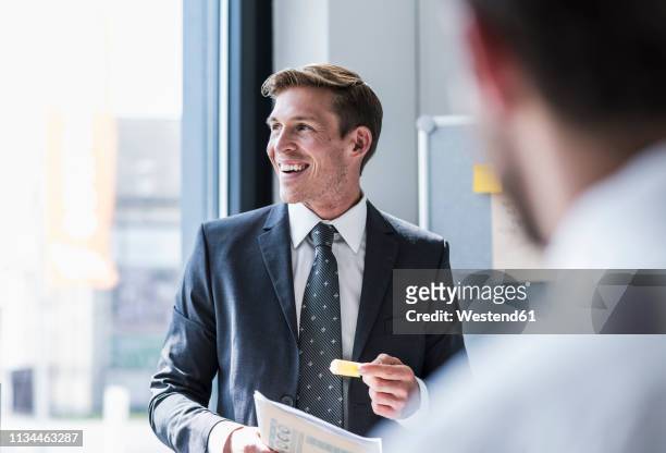 smiling businessman in a meeting in office - business suits discussion stock-fotos und bilder