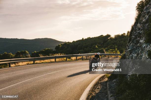 italy, elba island, female motorcyclist biking - biker stock-fotos und bilder