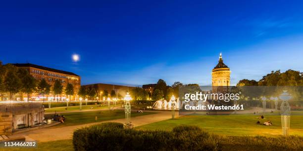 germany, mannheim, friedrichsplatz with fountain and water tower in the background in the evening - mannheim stock pictures, royalty-free photos & images