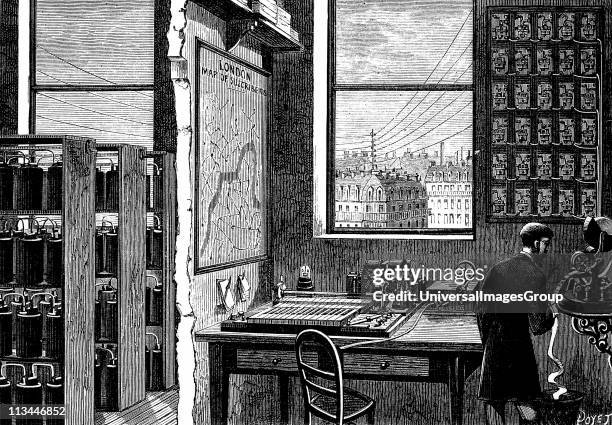 Main station of Exchange Telegraph Company, London, England,showing operator receiving a message on ticker-tape machine. Morse transmitting...