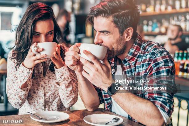couple relaxing in a cafe - flirting imagens e fotografias de stock
