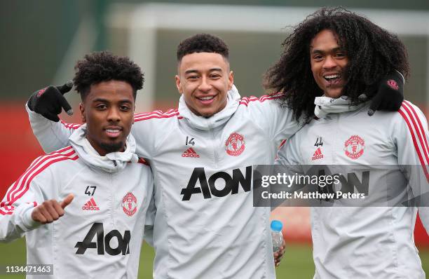 Angel Gomes, Jesse Lingard and Tahith Chong of Manchester United in action during a training session at Aon Training Complex on March 08, 2019 in...