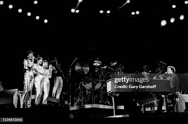 American Pop and R&B group the Pointer Sisters perform eith musician Lionel Richie, on piano, as they performs onstage at Radio City Music Hall, New...
