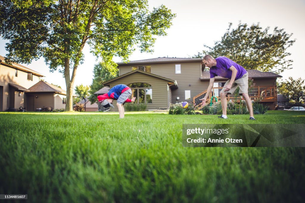 Boy Hiking a football to his dad