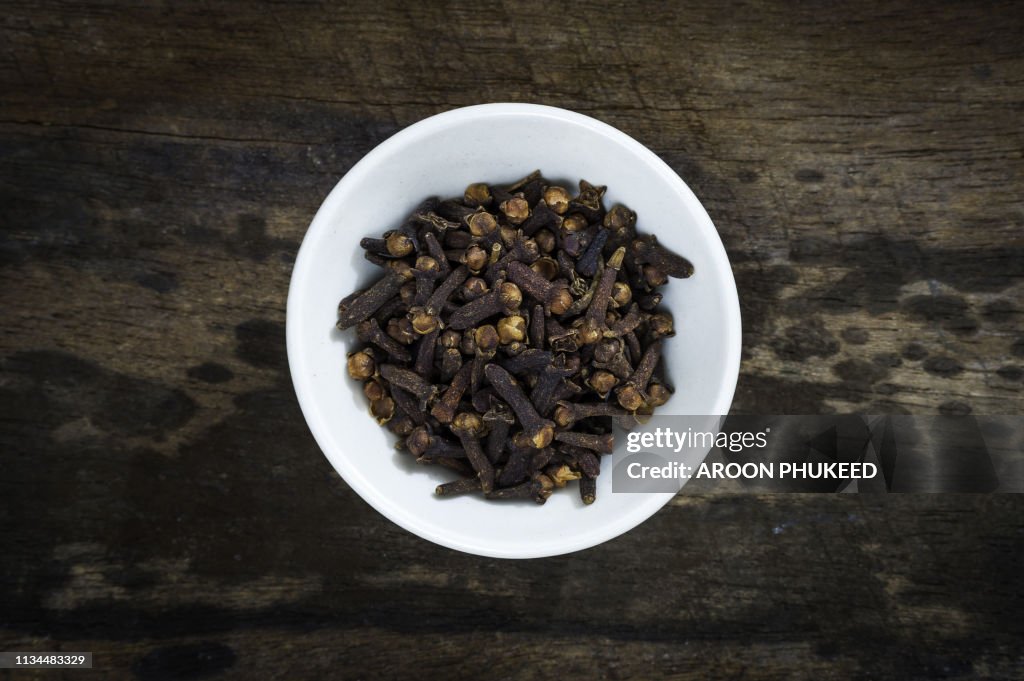 Heap of dried cloves in bowl