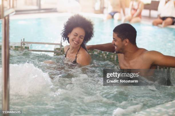 couple relaxing in a hot tub at spa - african american woman bath stock pictures, royalty-free photos & images