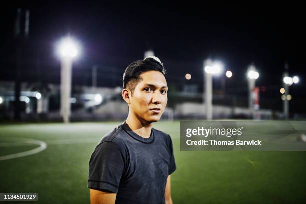 portrait of male soccer player on field during evening game - self improvement stock-fotos und bilder