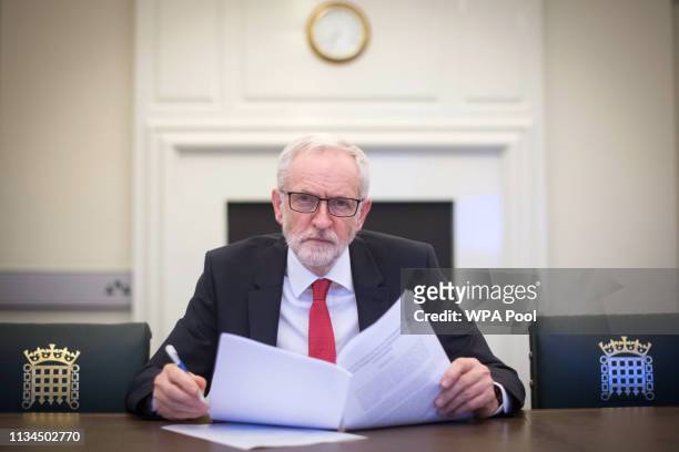 Labour leader Jeremy Corbyn poses with the Political Declaration setting out the framework for the future UK-EU relationship, in his office in the...
