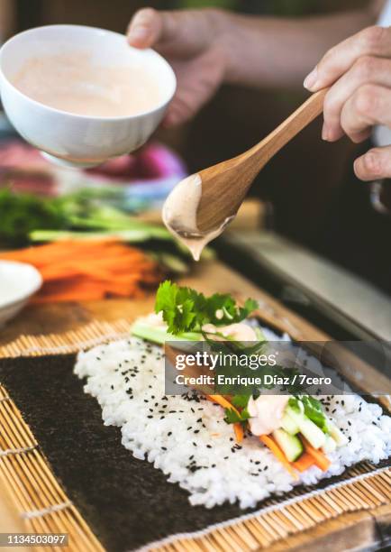 making sushi at home, adding mayonnaise - hand roll stock pictures, royalty-free photos & images
