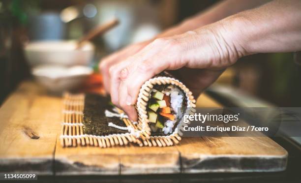 making sushi at home, roll up 2 - sushi stock pictures, royalty-free photos & images