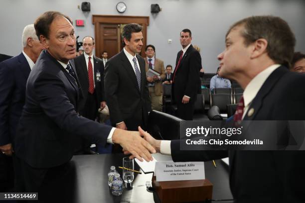 Supreme Court Associate Justice Samuel Alito shakes hands with Rep. Mike Quigley after a hearing about the court's budget during a hearing of the...