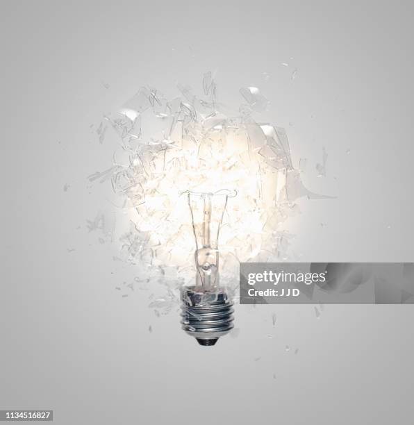 close up of light bulb shattering - exploding lightbulb stock pictures, royalty-free photos & images