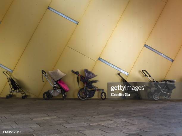 row of parked pushchairs in 8 house, copenhagen, denmark - baby carriage stock pictures, royalty-free photos & images