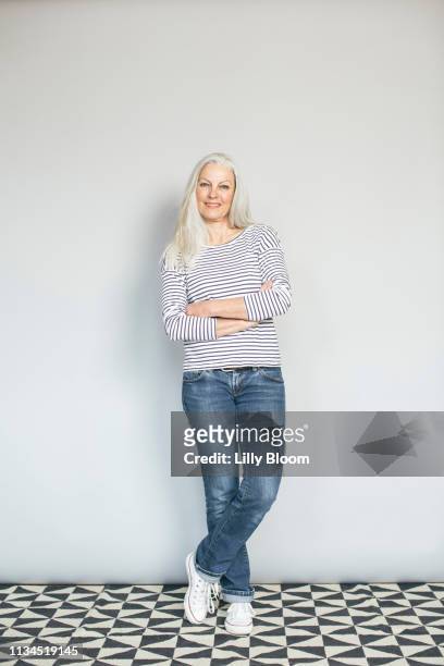 woman in confident pose - striped trousers stock pictures, royalty-free photos & images