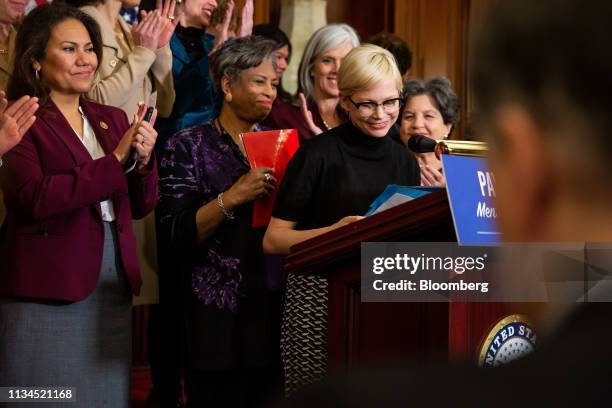 Actress Michelle Williams, center right, smiles during a news conference for Equal Pay Day in Washington, D.C., U.S., on Tuesday, April 2, 2019....