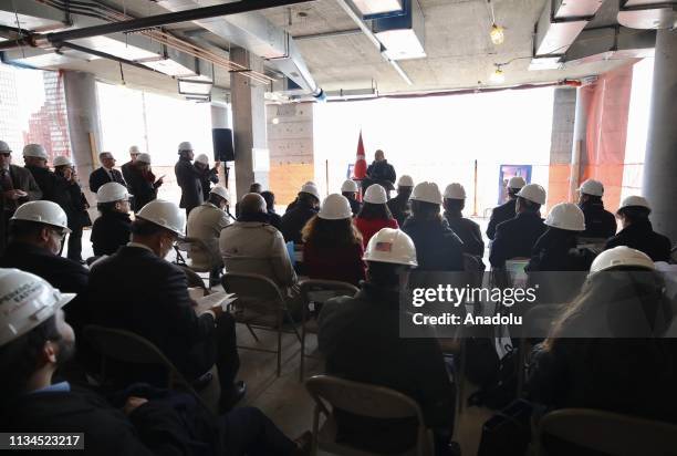 Turkish Foreign Affairs Minister Mevlut Cavusoglu delivers a speech during a ceremony of the last concrete bucket to be carried to the top 35th floor...