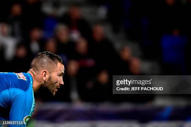 Scares are seen on Lyon's French-Portuguese goalkeeper Anthony Lopes' face after was injured during the French Cup semi-final football match between...