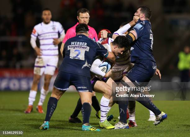 George Worth of Leicester Tigers is tackled by James Phillips and Rob Webber of Sale Sharks during the Gallagher Premiership Rugby match between Sale...