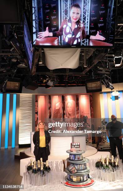 Dra Ana Maria Polo is seen viewing a video message from Alejandra Guzman on the set of "Caso Cerrado" during the 18th anniversary celebration of her...