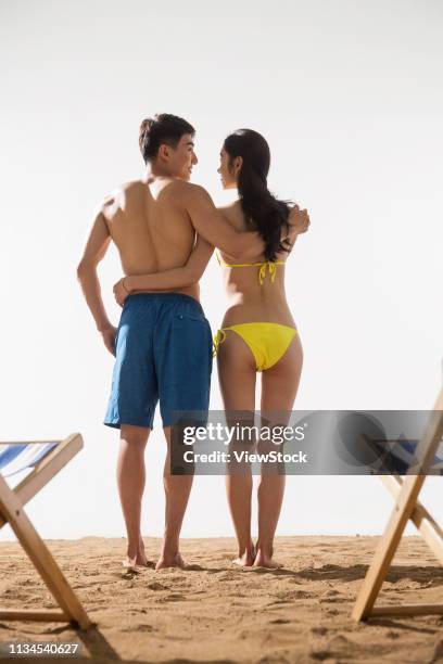 romantic couple on the beach - couple standing full length stock pictures, royalty-free photos & images