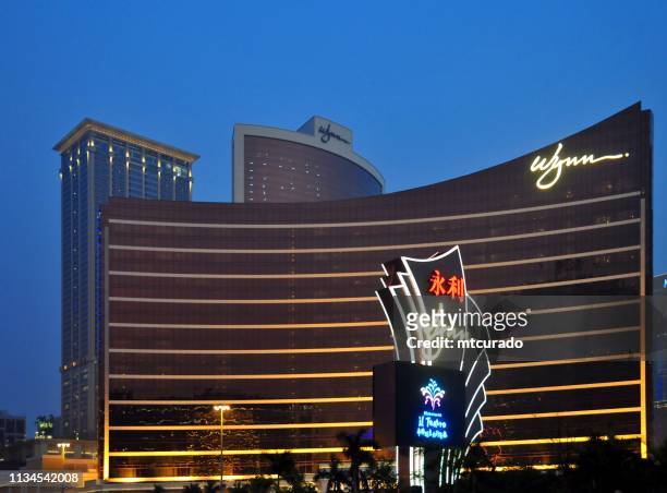 wynn macau  hotel and casino and sign at dusk, macau, china - wynn las vegas stock pictures, royalty-free photos & images