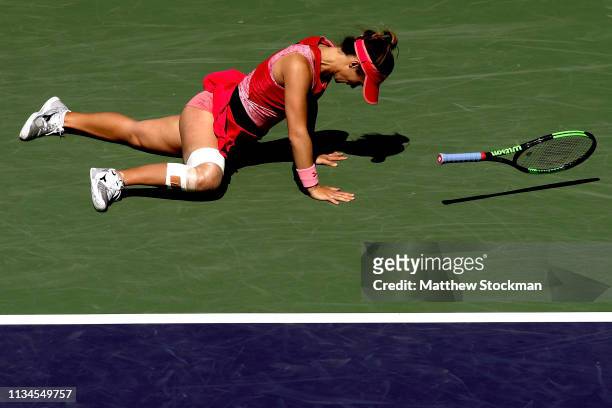 Lauren Davis falls while playing Garbine Muguruza of Spain during the BNP Paribas Open at the Indian Wells Tennis Garden on March 08, 2019 in Indian...