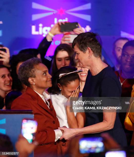 Chicago mayor elect Lori Lightfoot celebrates her victory with wife Amy Eshleman after speaking during the election night party in Chicago, Illinois...