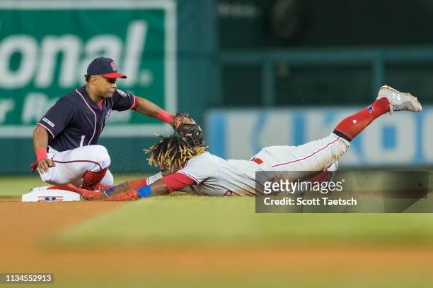Odubel Herrera of the Philadelphia Phillies slides safely into second base ahead of the throw to Wilmer Difo of the Washington Nationals during the...