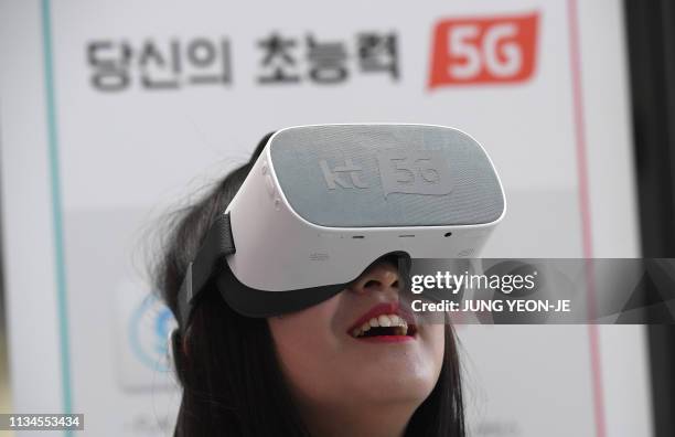In a picture taken on April 2 an employee demonstrates 5G services on a VR device during a press conference of South Korean telecom operator KT in...