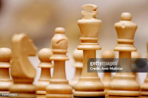 chess pieces on chess board - token stock pictures, royalty-free photos & images